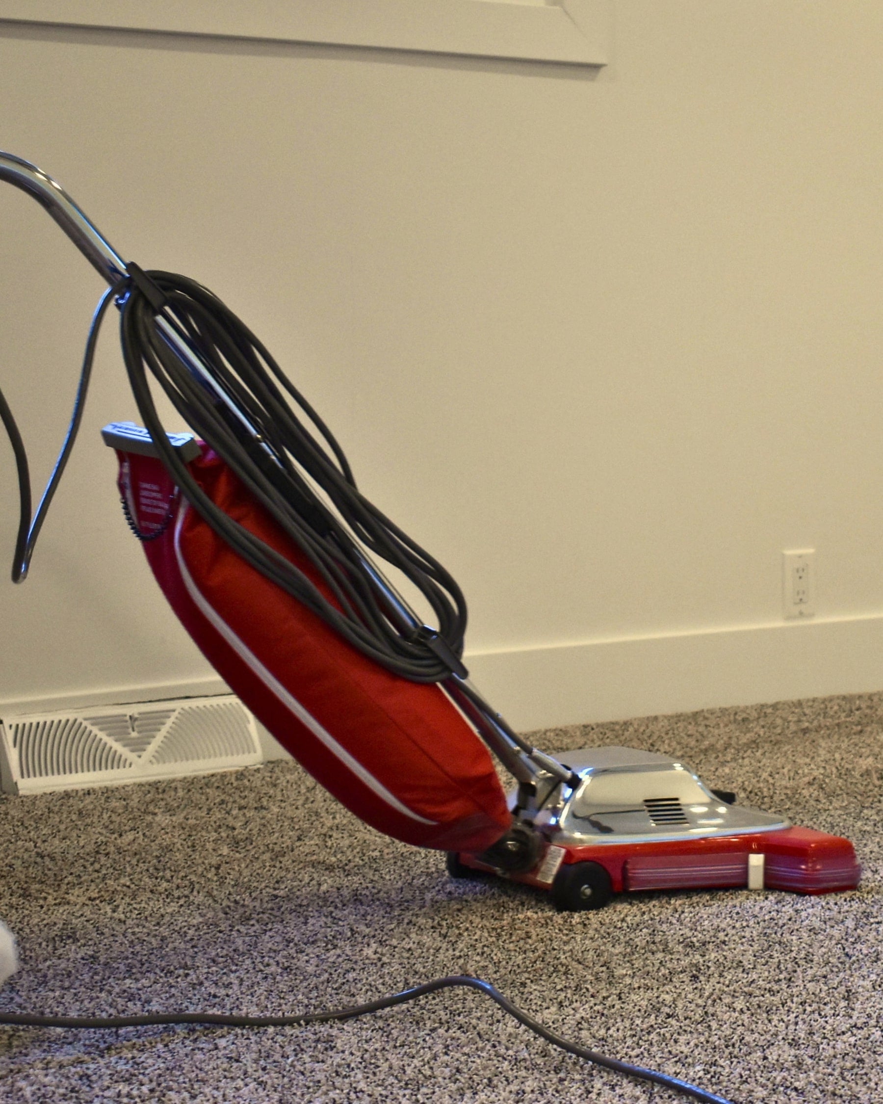 A red commercial vacuum on freshly cleaned carpet